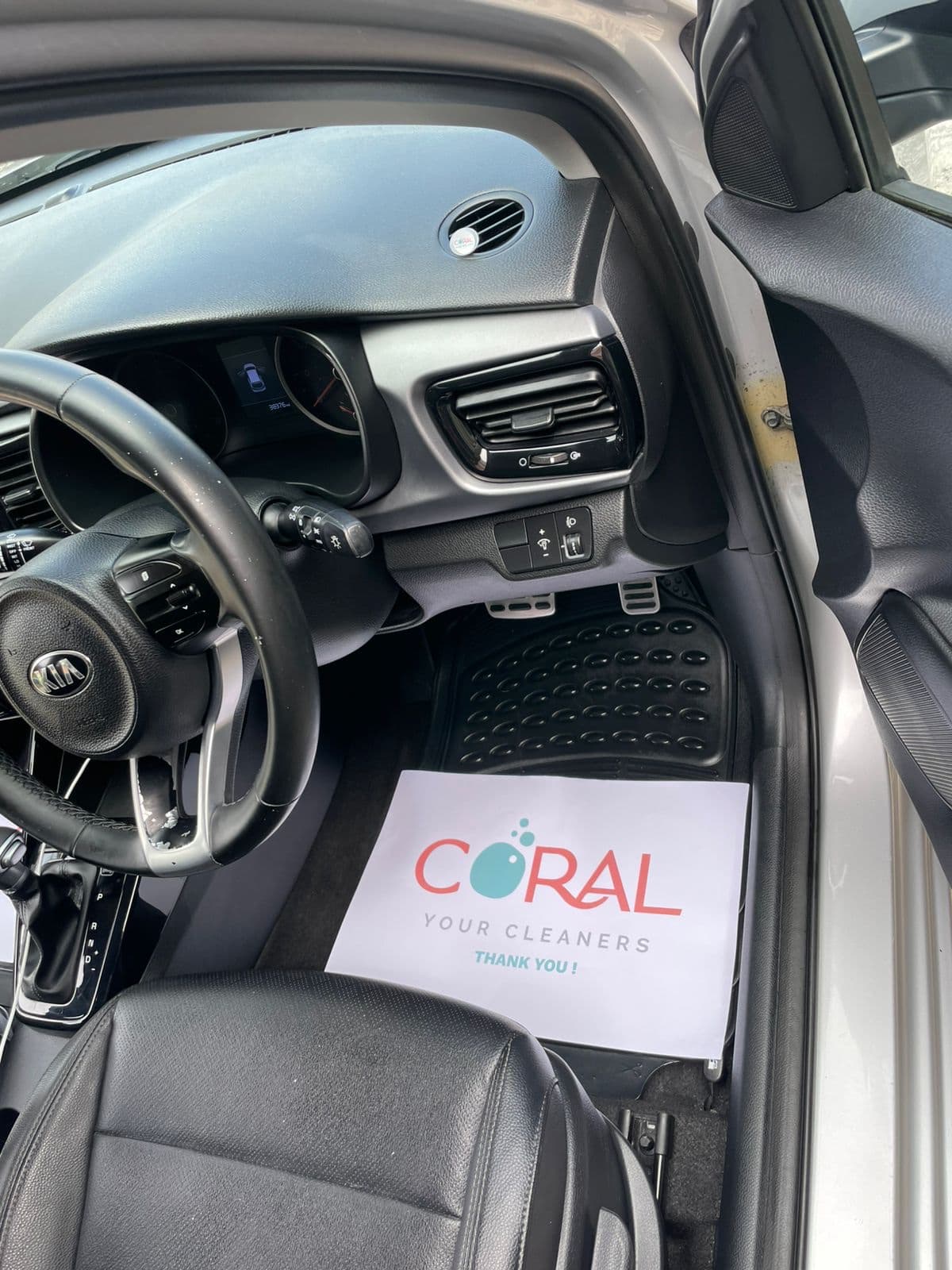 Detailed dashboard and front mats with a Coral Cleaners thank-you sheet
